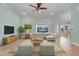 Stylishly furnished living room with pool views, tile flooring, and natural light at 8709 Augusta Ct, Clermont, FL 34711