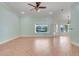 Bright living room with tile floors and a view of the pool through large windows at 8709 Augusta Ct, Clermont, FL 34711