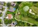 Panoramic aerial view of neighborhood featuring golf course, houses with pools, and winding streets at 9010 Laurel Ridge Dr, Mount Dora, FL 32757