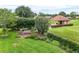 Scenic backyard view with manicured landscaping and a building overlooking the golf course at 9010 Laurel Ridge Dr, Mount Dora, FL 32757