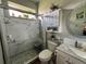 Bathroom with a glass walk-in shower, rock floor, and updated fixtures at 9010 Laurel Ridge Dr, Mount Dora, FL 32757