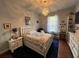 Cozy bedroom featuring a chandelier, hardwood floors, and a comfortable seating area at 9010 Laurel Ridge Dr, Mount Dora, FL 32757