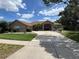 Stunning single-story home with a beautifully landscaped front yard and a spacious concrete driveway at 9010 Laurel Ridge Dr, Mount Dora, FL 32757