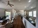 Spacious open-concept living room featuring hardwood floors, multiple seating areas, and access to outdoor living at 9010 Laurel Ridge Dr, Mount Dora, FL 32757