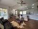 Open concept living room featuring hardwood floors, recessed lighting, and an abundance of natural light at 9010 Laurel Ridge Dr, Mount Dora, FL 32757