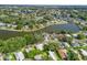 Aerial view of the neighborhood featuring a lake and well-maintained landscaping at 941 Tarrson Blvd, Lady Lake, FL 32159