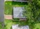 Aerial view of a home's rooftop, set amidst a lush green landscape, highlighting its location at 941 Tarrson Blvd, Lady Lake, FL 32159