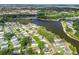 Beautiful aerial view of lakeside community with mature trees, highlighting the waterfront appeal at 941 Tarrson Blvd, Lady Lake, FL 32159