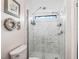 Bathroom shower with a glass door and white marble-look tile, offering a sleek design at 941 Tarrson Blvd, Lady Lake, FL 32159