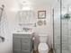 Charming bathroom with nautical decor, gray vanity, and a shower with glass door at 941 Tarrson Blvd, Lady Lake, FL 32159