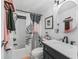 Stylish bathroom with a marble countertop vanity, round mirror, and a shower with a patterned curtain at 941 Tarrson Blvd, Lady Lake, FL 32159