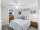 Cozy bedroom features bright windows, ceiling fan, neutral walls, and built in entertainment center at 941 Tarrson Blvd, Lady Lake, FL 32159