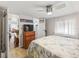 Comfortable bedroom featuring a ceiling fan, a mounted TV, and a door to a modern bathroom at 941 Tarrson Blvd, Lady Lake, FL 32159