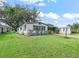 Cozy home with lush green lawn, covered parking area, and well-kept landscaping at 941 Tarrson Blvd, Lady Lake, FL 32159