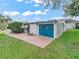 Charming garage with a bright blue door and a well-maintained lawn, offering curb appeal at 941 Tarrson Blvd, Lady Lake, FL 32159