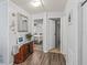 Hallway leading to bedrooms, featuring stylish decor and ample lighting at 941 Tarrson Blvd, Lady Lake, FL 32159