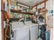 Utility room featuring washer and dryer, with storage shelves and various household supplies at 941 Tarrson Blvd, Lady Lake, FL 32159