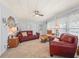 Comfortable living room featuring plush seating, neutral carpeting, and bright, airy ambiance at 941 Tarrson Blvd, Lady Lake, FL 32159