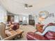 Inviting living room with plush leather seating, ceiling fan, and plenty of natural light at 941 Tarrson Blvd, Lady Lake, FL 32159