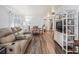 Cozy living room featuring a plush reclining sofa, dining table, and stylish decor at 941 Tarrson Blvd, Lady Lake, FL 32159