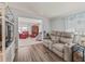 Comfortable living room showcases a recliner sofa, wood floors and serene decor at 941 Tarrson Blvd, Lady Lake, FL 32159