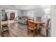 Inviting living space with wood floors, a reclining sofa, and round dining table at 941 Tarrson Blvd, Lady Lake, FL 32159