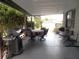 Covered outdoor patio with dining set, grill, and view of the surrounding neighborhood at 941 Tarrson Blvd, Lady Lake, FL 32159