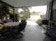 Covered outdoor patio with dining set and view of the surrounding neighborhood at 941 Tarrson Blvd, Lady Lake, FL 32159