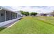 Backyard with an enclosed patio, providing a relaxing outdoor space at 9461 Se 173Rd Ln, Summerfield, FL 34491