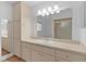 Bathroom features a large mirror, vanity, and shower at 9461 Se 173Rd Ln, Summerfield, FL 34491
