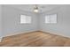 Comfortable bedroom featuring hardwood floors and ceiling fan at 9461 Se 173Rd Ln, Summerfield, FL 34491