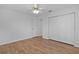 Bedroom featuring hardwood floors, closet, and ceiling fan at 9461 Se 173Rd Ln, Summerfield, FL 34491