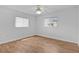 Bright bedroom featuring hardwood floors and a ceiling fan at 9461 Se 173Rd Ln, Summerfield, FL 34491