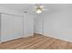 Bedroom featuring hardwood floors, ceiling fan and closet at 9461 Se 173Rd Ln, Summerfield, FL 34491