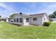 Exterior view of a well-maintained home with an enclosed patio at 9461 Se 173Rd Ln, Summerfield, FL 34491