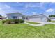 Charming single-story home featuring a well-manicured lawn and an attached two-car garage at 9461 Se 173Rd Ln, Summerfield, FL 34491