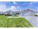 Charming single-story home featuring a well-manicured lawn and an attached two-car garage at 9461 Se 173Rd Ln, Summerfield, FL 34491