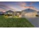 Charming single-story home featuring a well-manicured lawn and an attached two-car garage at 9461 Se 173Rd Ln, Summerfield, FL 34491