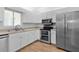 Well-lit kitchen featuring modern stainless steel appliances, ample counter space and hardwood floor at 9461 Se 173Rd Ln, Summerfield, FL 34491