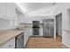 Well-lit kitchen featuring modern stainless steel appliances, ample counter space and hardwood floor at 9461 Se 173Rd Ln, Summerfield, FL 34491