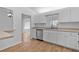 Bright and airy kitchen featuring white cabinets, stainless steel appliances, and hardwood floors at 9461 Se 173Rd Ln, Summerfield, FL 34491