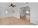Living room with an arched doorway leading to dining and kitchen areas at 9461 Se 173Rd Ln, Summerfield, FL 34491