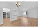 Spacious living room with hardwood floors and views into kitchen at 9461 Se 173Rd Ln, Summerfield, FL 34491