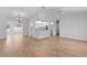 Open-concept living room flows into the kitchen with hardwood flooring throughout at 9461 Se 173Rd Ln, Summerfield, FL 34491