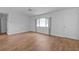 Cozy living room featuring hardwood floors and a bright window at 9461 Se 173Rd Ln, Summerfield, FL 34491