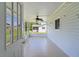 Bright, airy enclosed patio featuring neutral tile floor and a ceiling fan for comfortable outdoor living at 9461 Se 173Rd Ln, Summerfield, FL 34491