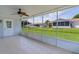 Enjoy outdoor views from this screened patio with tile flooring and a ceiling fan at 9461 Se 173Rd Ln, Summerfield, FL 34491