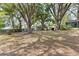 Expansive backyard featuring mature trees providing shade and a small shed at 9752 County Road 121, Wildwood, FL 34785