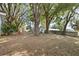 Over-sized backyard with mature trees and a play set, offering a private outdoor escape at 9752 County Road 121, Wildwood, FL 34785