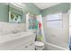 Bathroom featuring a shower-tub combo, vanity, and bright natural light at 9752 County Road 121, Wildwood, FL 34785